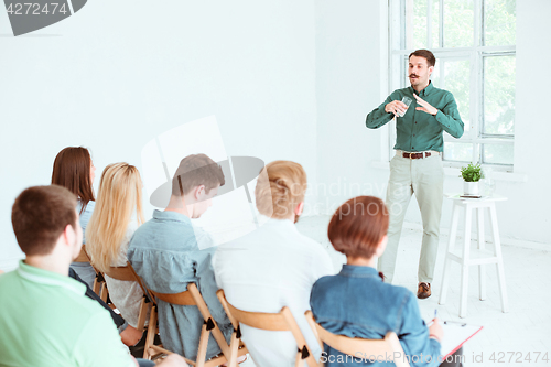 Image of Speaker at Business Meeting in the conference hall.