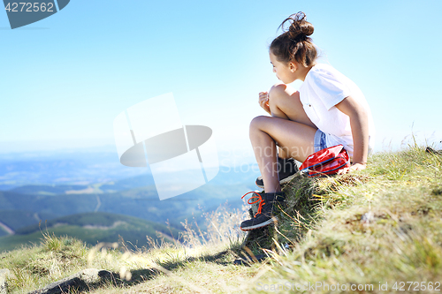 Image of Child sticking plaster on knee.