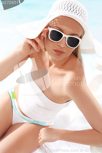 Image of Sun holiday ­ relaxing on the beach  Fashion at the beach ­ beautiful woman in costume