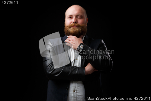 Image of Satisfied man stroking ginger beard