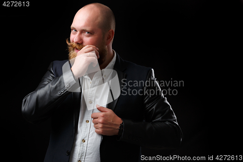 Image of Man twirling his ginger mustaches