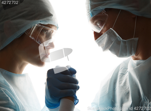 Image of Doctors in gloves make handshake
