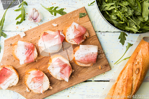 Image of Bacon with white bread ,arugula ,