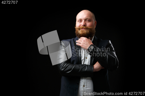 Image of Pleased man stroking ginger beard