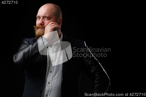 Image of Man curls his ginger mustache