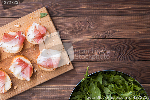 Image of Bread and bacon ,brown table