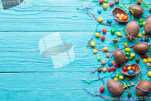 Image of Chocolate eggs, colorful candy ,ribbons