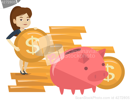 Image of Business woman putting coin in piggy bank.