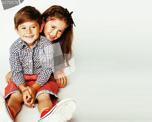 Image of little cute boy and girl hugging playing on white background, ha