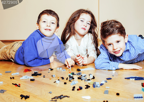 Image of funny cute children playing toys at home, boys and girl smiling, first education role close up, lifestyle people concept