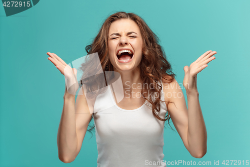 Image of Portrait of young woman with shocked facial expression