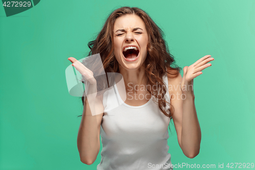 Image of Portrait of young woman with shocked facial expression