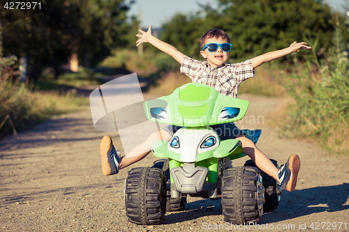 Image of Happy little boy playing on road at the day time.