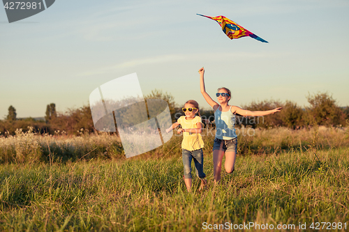 Image of Happy children playing on the field at the day time.