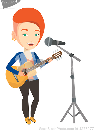 Image of Woman singing in microphone and playing guitar.