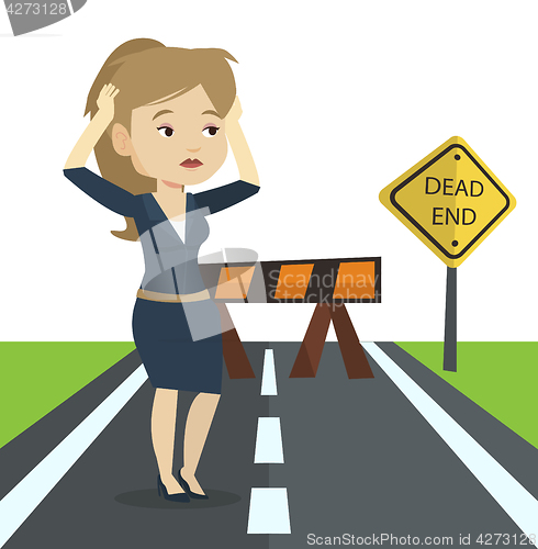 Image of Business woman looking at road sign dead end.