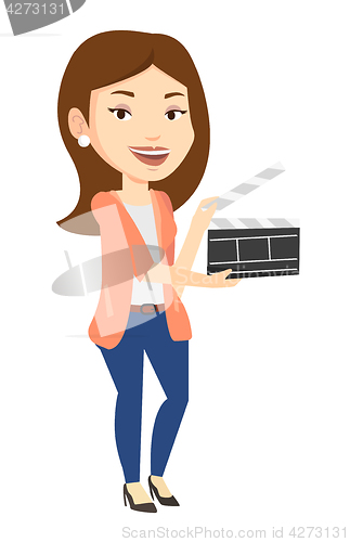 Image of Smiling woman holding an open clapperboard.