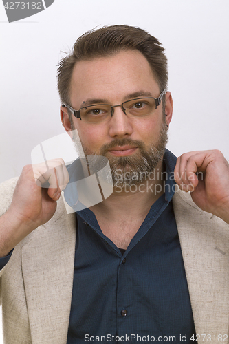 Image of Young man arranges his shirt