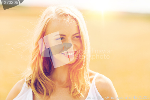 Image of smiling young woman in white on cereal field