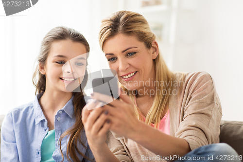 Image of happy family with smartphone at home