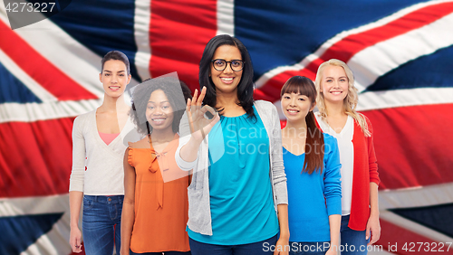 Image of international english happy women showing ok