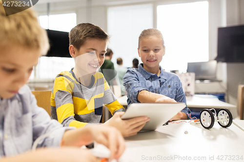 Image of kids with tablet pc programming at robotics school