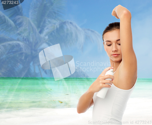 Image of woman with antiperspirant deodorant over beach