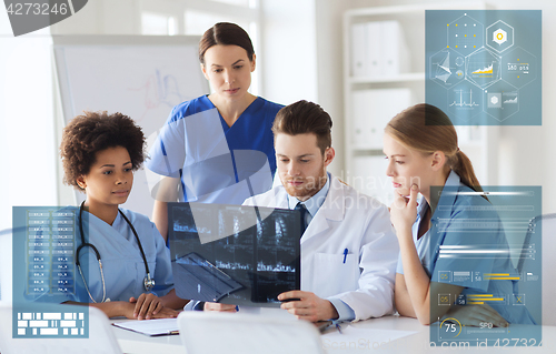 Image of group of doctors discussing x-ray scan at hospital