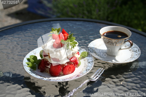 Image of Pastry with strawberries and a cup of strong coffee