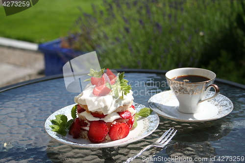 Image of Pastry with sweet strawberries and a cup of strong coffee