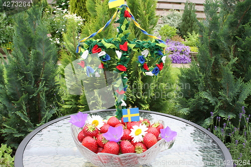 Image of Swedish strawberries for Midsummer with may-pole in background