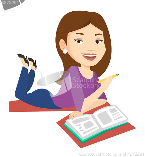 Image of Student laying on the floor and reading book.
