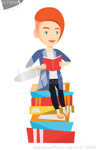Image of Student sitting on huge pile of books.