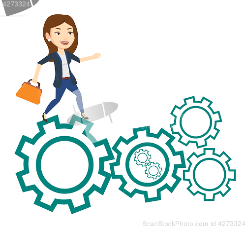 Image of Business woman running on cogwheels.