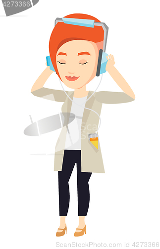 Image of Young woman in headphones listening to music.