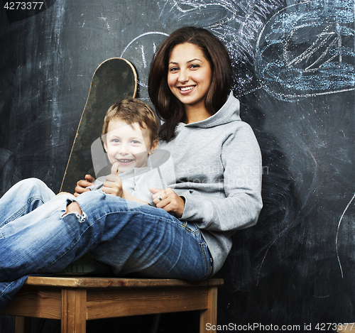 Image of young hipster teenage girl sitting with her brother in classroom