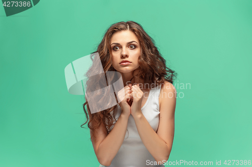 Image of Portrait of young woman with shocked facial expression