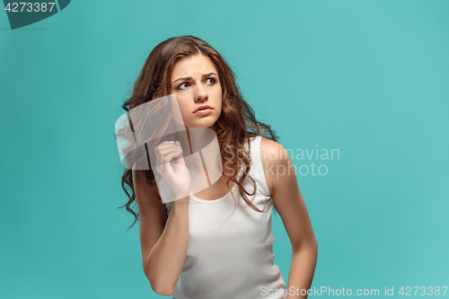 Image of Portrait of young woman with shocked facial expression