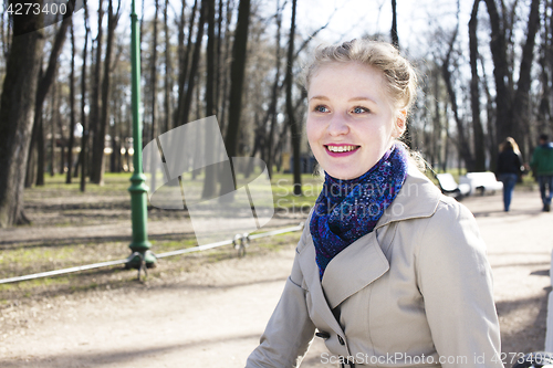 Image of young pretty blonde girl enjoing spring nature in park, lifestyle people concept 