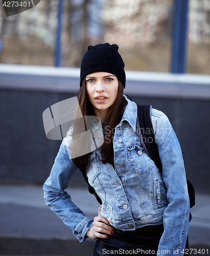 Image of young pretty girl near business building walking