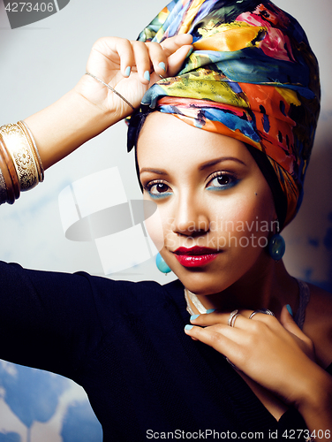 Image of beauty bright african woman with creative make up, shawl on head