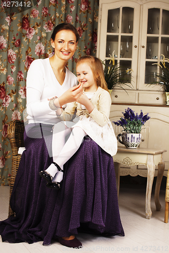 Image of young mother with daughter at luxury home interior vintage