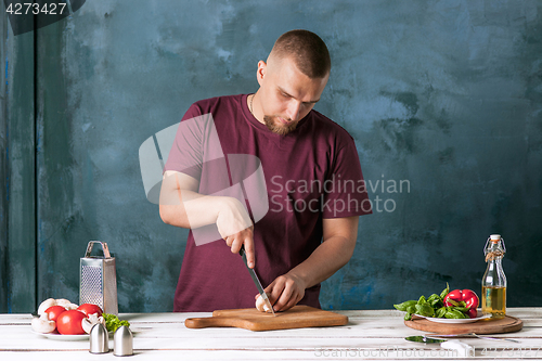 Image of Closeup hand of chef baker making pizza at kitchen