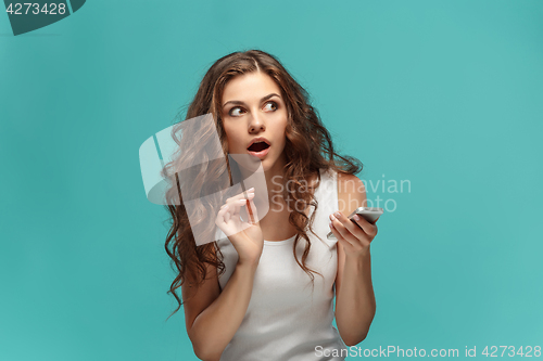 Image of Portrait of young woman with shocked facial expression