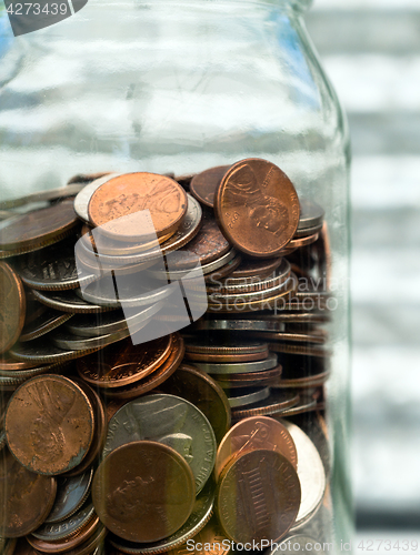 Image of American Dollar Currency Coins in Jar Pennies Nickels Quarters D