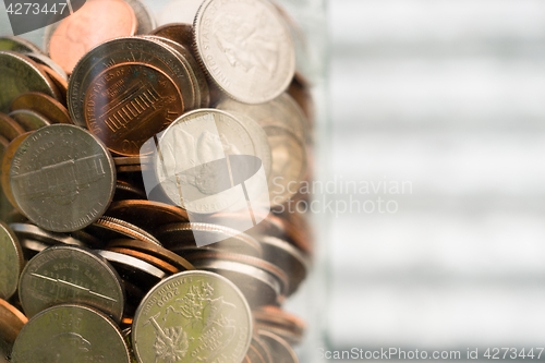 Image of American Dollar Currency Coins in Jar Pennies Nickels Quarters D