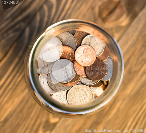 Image of American Dollar Currency Coins in Jar Pennies Nickels Quarters D