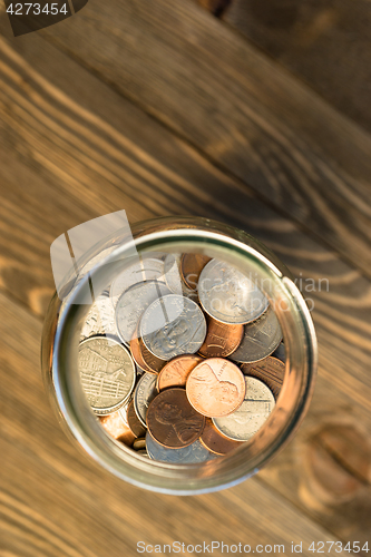 Image of American Dollar Currency Coins in Jar Pennies Nickels Quarters D