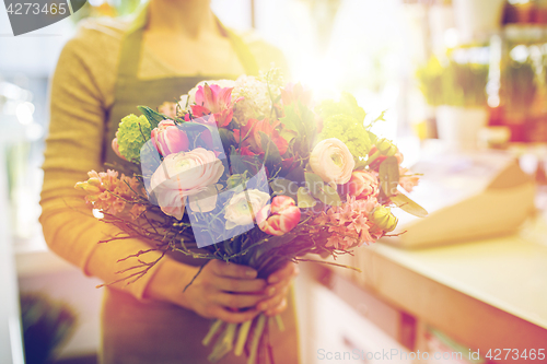 Image of close up of woman holding bunch at flower shop