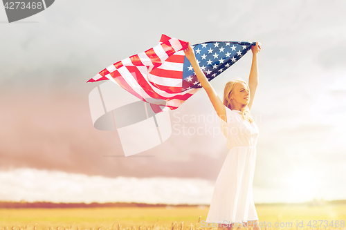 Image of happy woman with american flag on cereal field